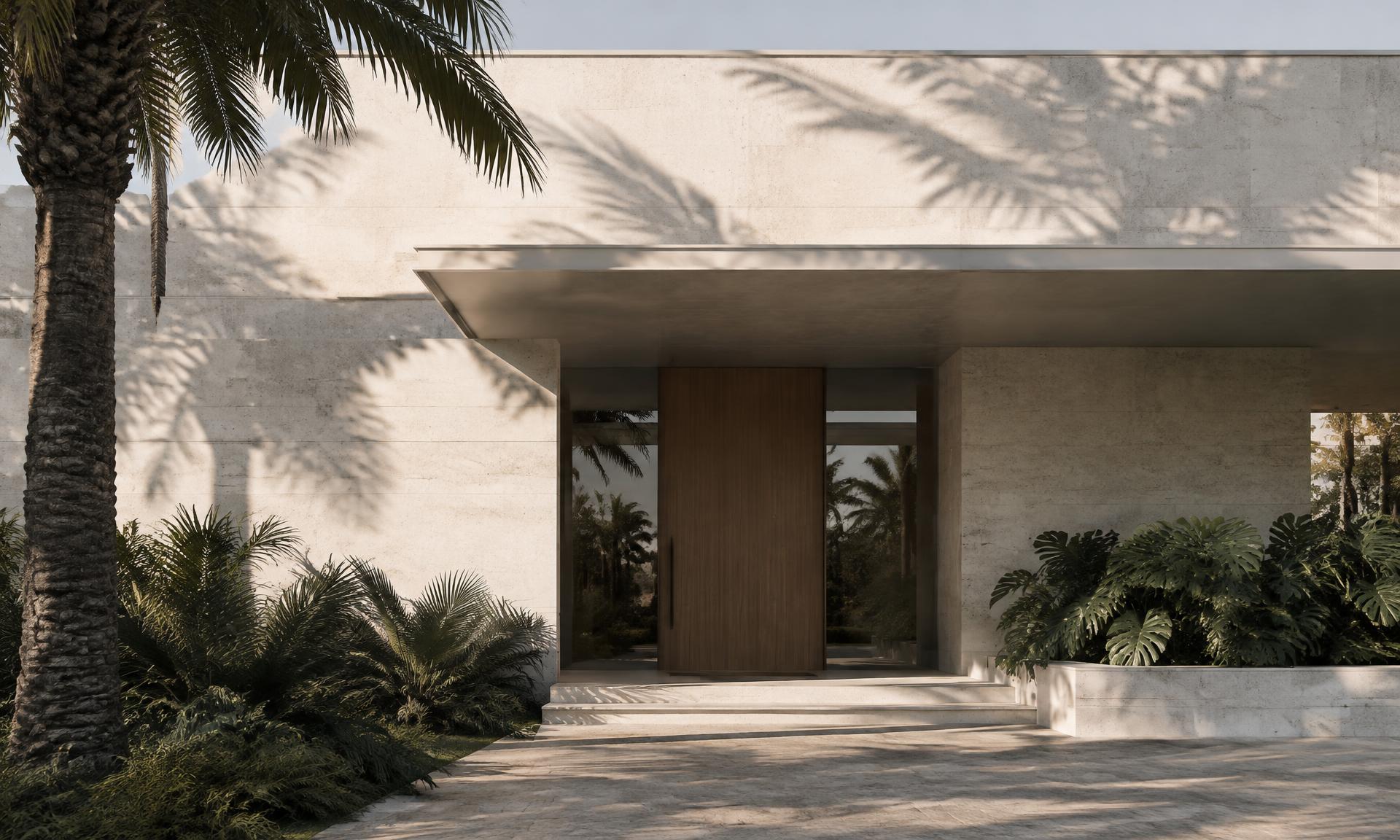 Limestone facade of a modern Florida residence with a deep entry canopy and palm shadows